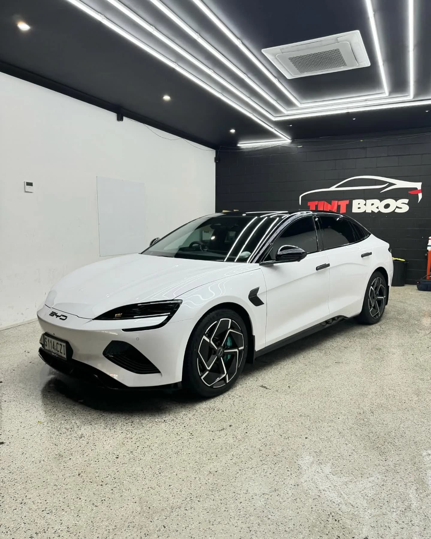 White BYD Seal fitted with ceramic window tint at the Tint Bros workshop