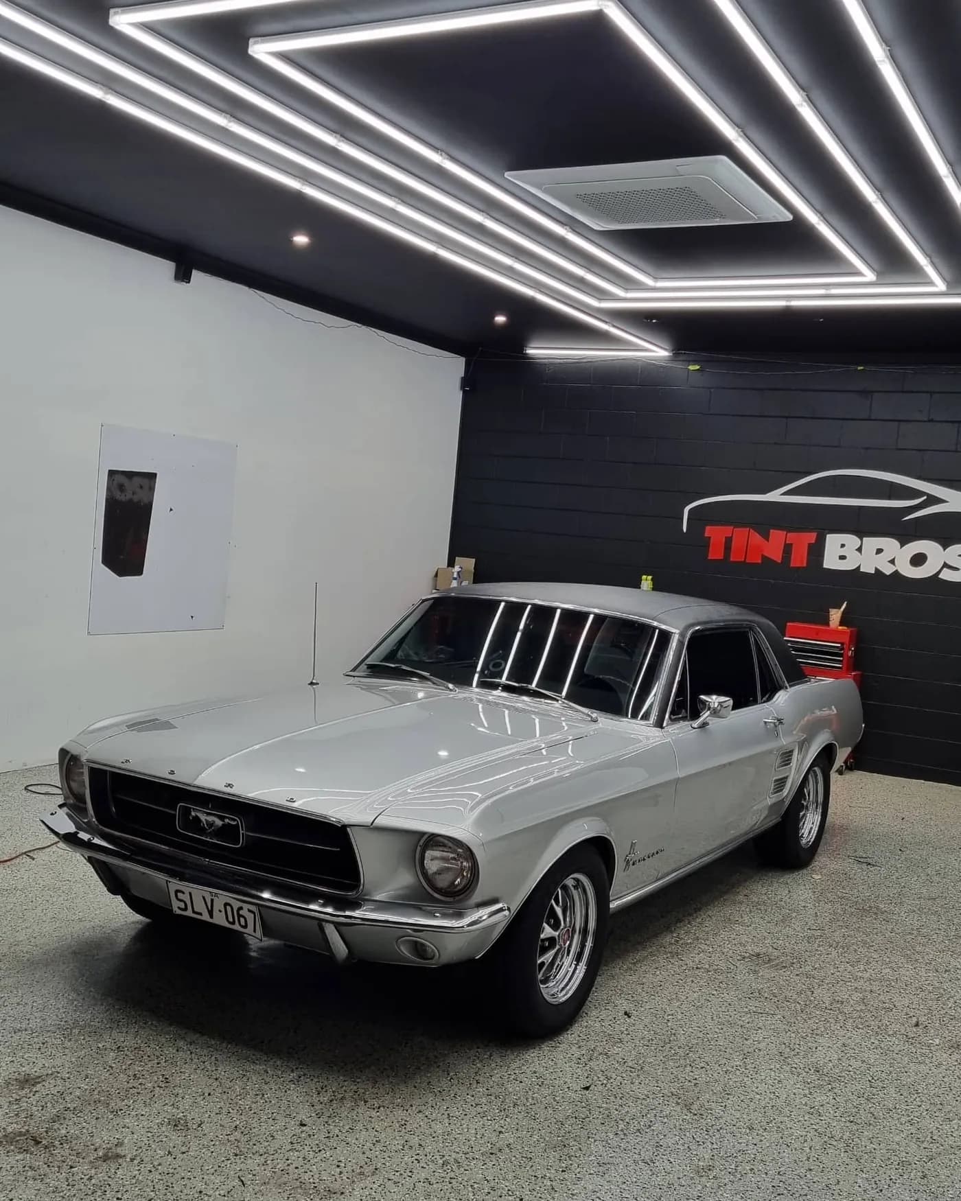 Classic 1967 Ford Mustang tinted in the darkest legal shade at the Tint Bros studio