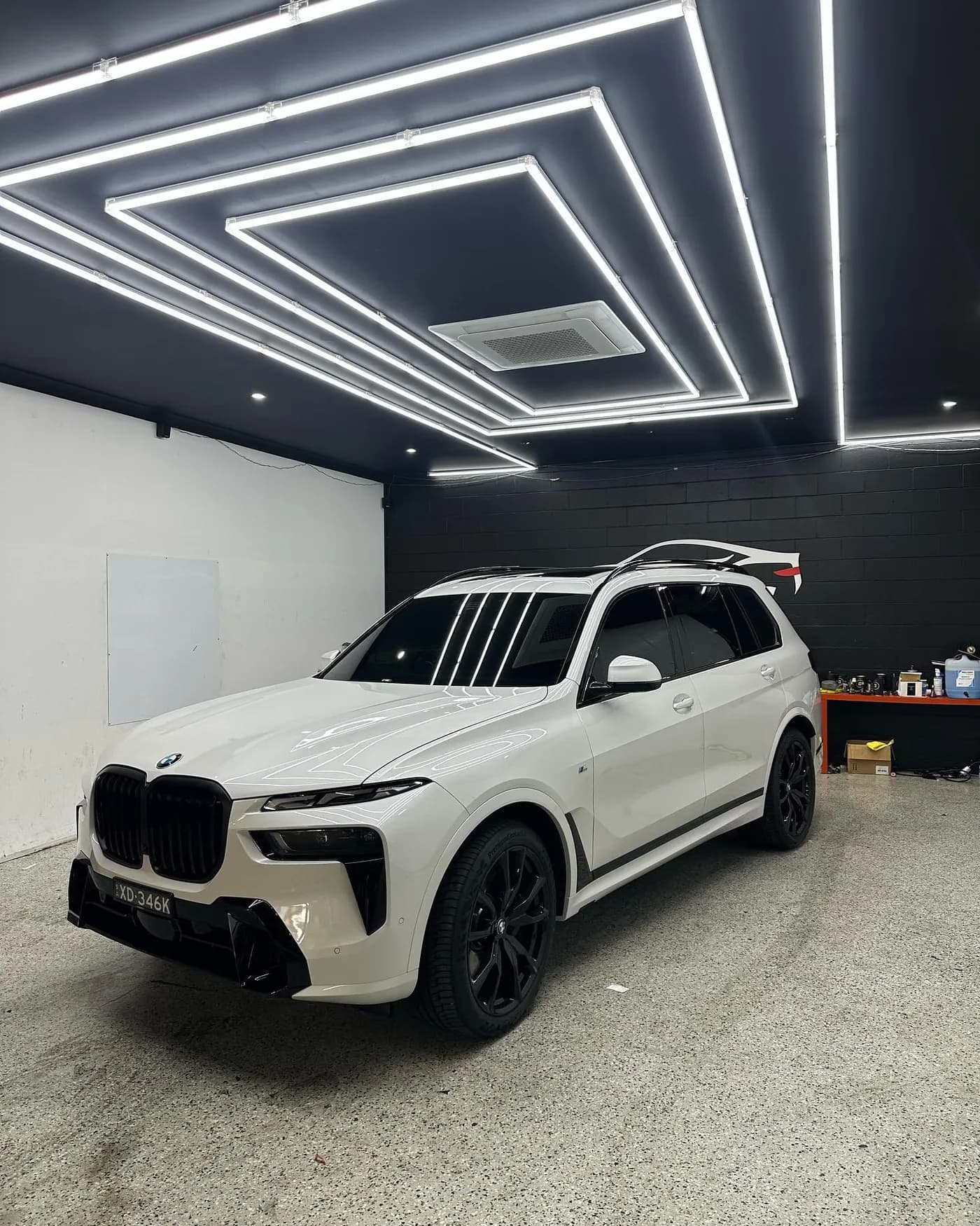 A BMW X7 fitted with a clean ceramic window tint at the Tint Bros studio