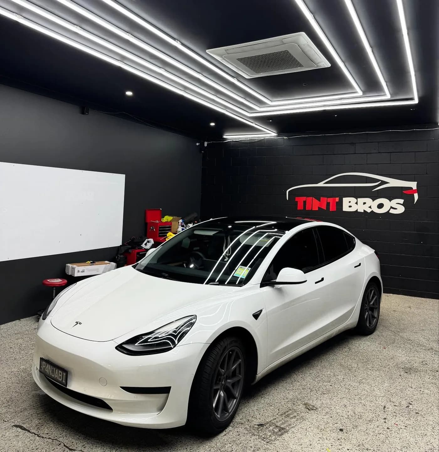 Tesla Model 3 with sides, rear glass and sunroof tinted in Rayno S9 Phantom by Tint Bros Adelaide