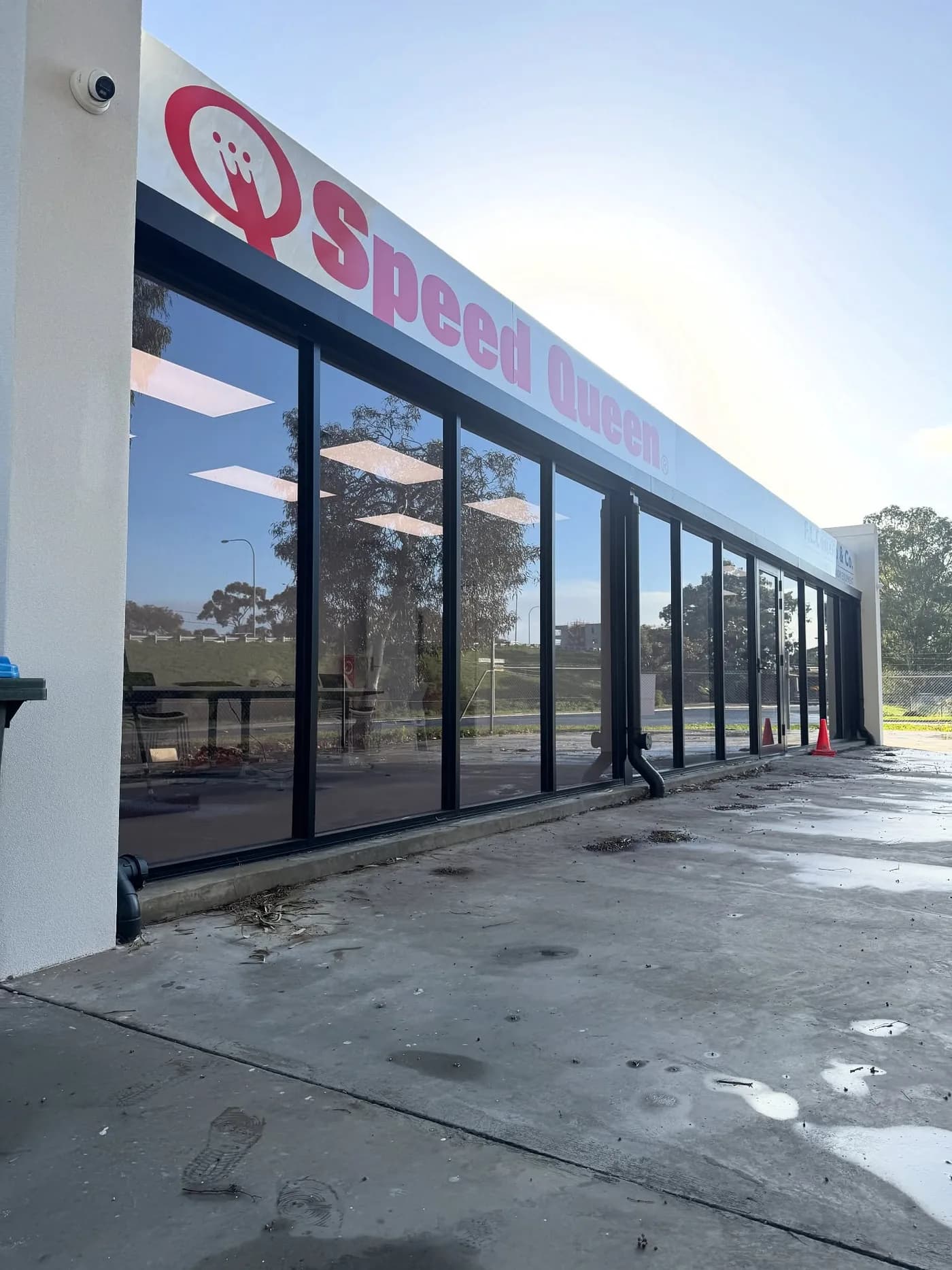 Speed Queen Laundromat office in Adelaide tinted with charcoal film for privacy and heat rejection by Tint Bros