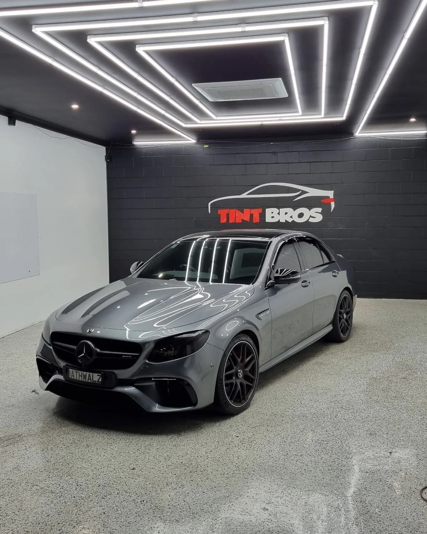 Mercedes-AMG E63 with Rayno Phantom window tint and blacked-out headlights and taillights